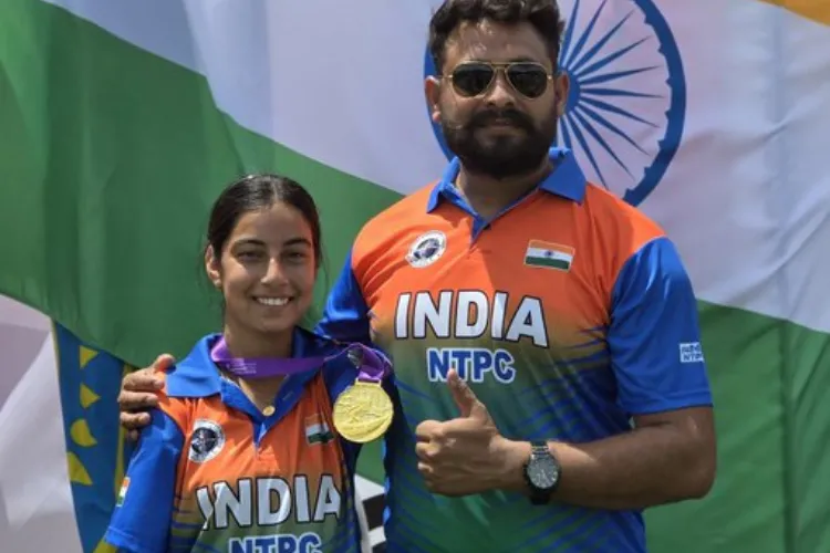 Coach displaying gold medal for Sheelat Devi inWorld Para Archery Championship at Gwangju (South Korea)