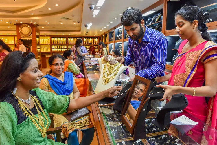 A woman tries on an ornament at a jewellery showroom