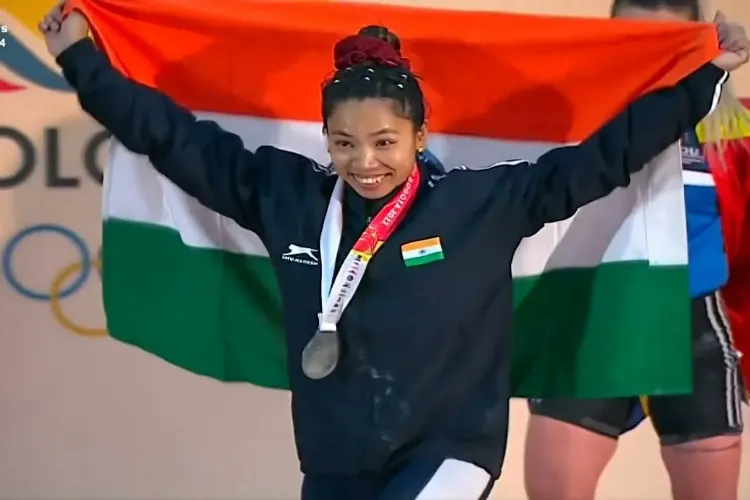 Mirabai Chanu with her silver medal and Indian flag