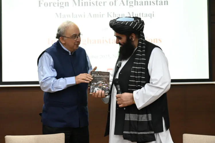 Diplomat and author Tilak Daveshvar presenting his book to Amir Khan Muttaqi
