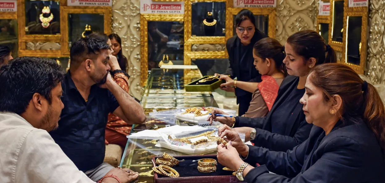 People buying gold in a shop in Old Delhi on Dhanteras