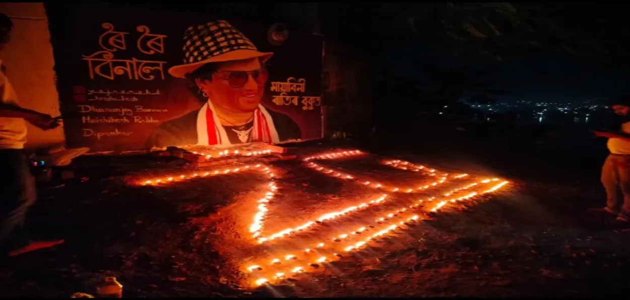 People lit diyas at a roadside shrine for Zubeen Garg in Guwahati