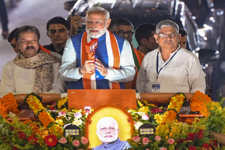 Prime Minister Narendra Modi, center, Union Minister Rajiv Ranjan alias Lalan Singh, right, and Bihar BJP President Dilip Kumar Jaiswal during an election roadshow for the Bihar Assembly polls, in Patna