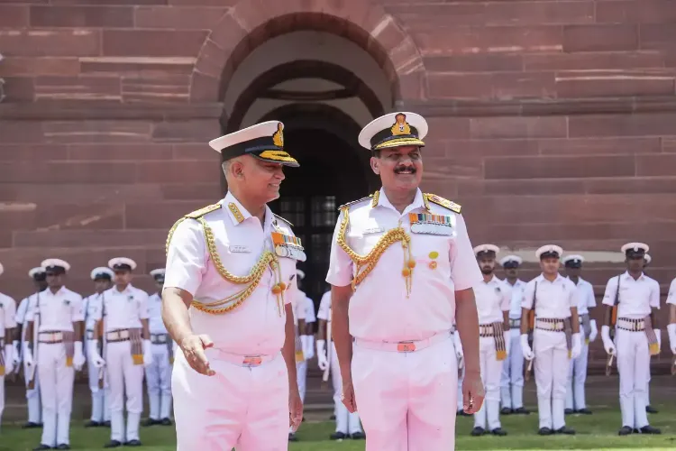 Admiral Dinesh Kumar Tripathi (R) with outgoing Navy Chief Adm R. Hari Kumar during a guard of honour ceremony before assuming charge as the 26th Navy chief