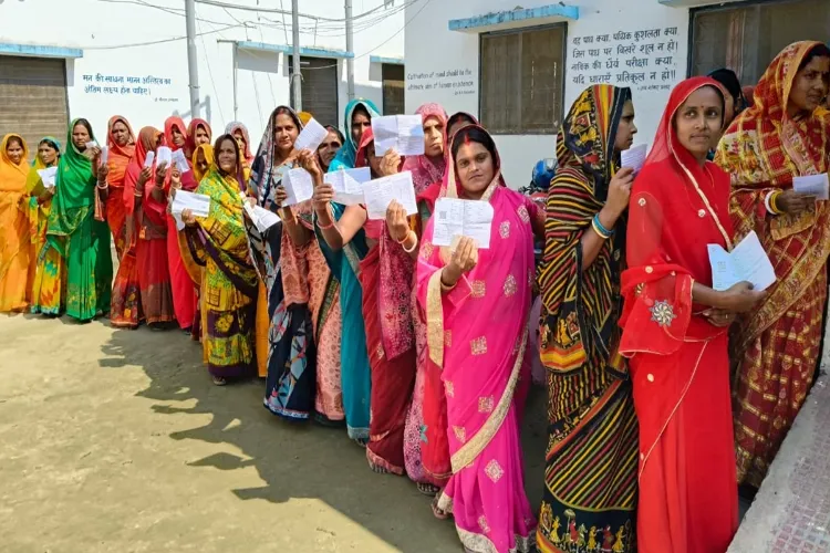 Women stand in queue to cast their votes in Bihar