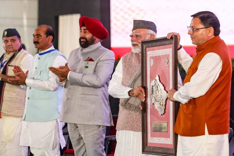 PM Modi being felicitated by Uttarakhand CM Dhami during the inauguration and foundation stone laying of various projects on the occasion of Uttarakhand Formation Day