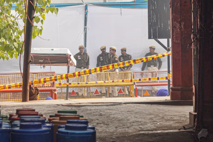 Security personnel keep vigil at a cordoned-off area a day after an explosion, near the Red Fort, in New Delhi