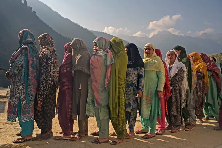 Women stand in queue to cast their vote in Kashmir