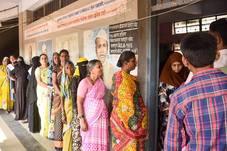 Karad: People wait in a queue to cast their votes at a polling booth during the Maharashtra local body elections