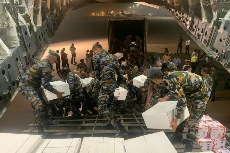 Security personnel carry relief materials and a 65-ton Bailey Bridge aboard IAF's C-17 aircraft for rescue operations in cyclone-hit Sri Lanka