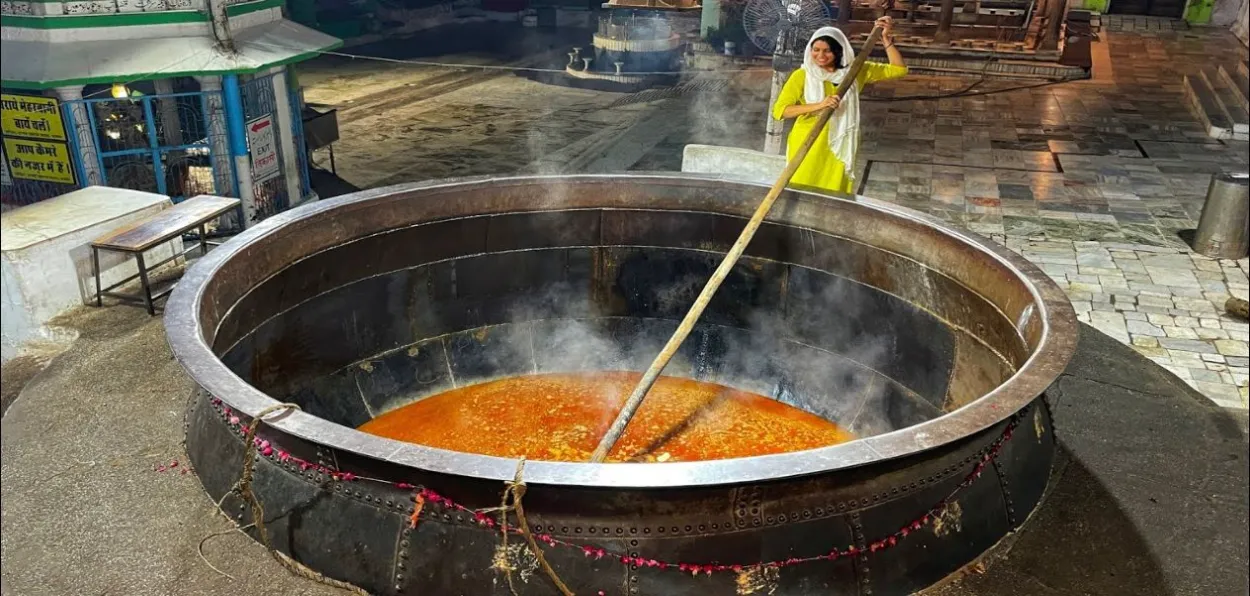 A woman lending a helping hand to cooking at Ajmer sharif dargah