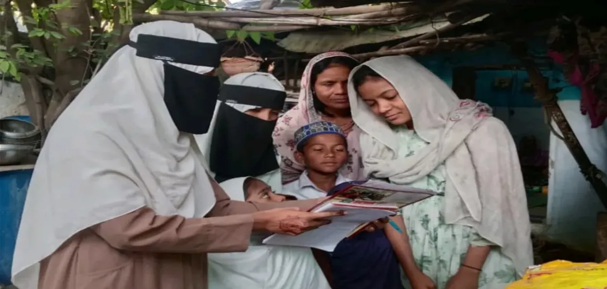 A member of SEWA interacting with a family
