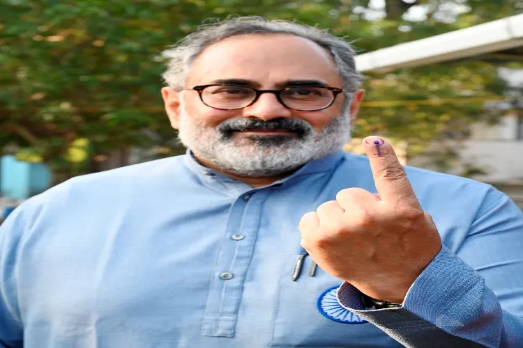 Kerala BJP President Rajeev Chandrasekhar shows his ink-marked finger after casting vote during the first phase of the state local body election, in Thiruvananthapuram