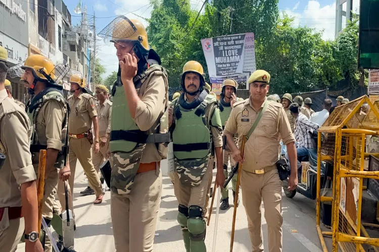 Police personnel stand guard during demolition of a building linked to an associate of arrested cleric Maulana Tauqeer Raza Khan, one of the accused in the Bareilly violence case, in Bareilly, Uttar Pradesh