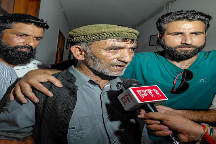 Shamasuddin Malik, the father of detained AAP MLA Mehraj Malik, speaks with the media, in Jammu and Kashmir