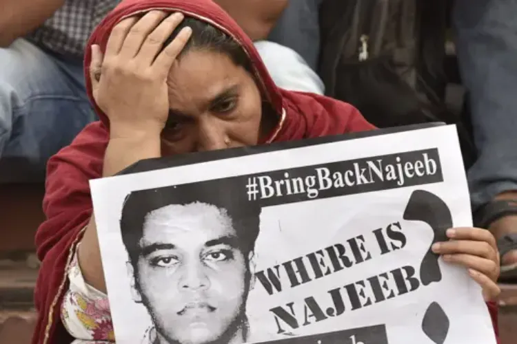 Fatima Nafees holding a placard about her missing JNU student son Najeeb Ahmed