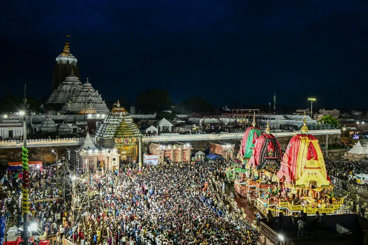 Devotees during 'Suna Besha' ceremony of Hindu deities Jagannath, Balabhadra and Subhadra, in Puri, Odisha