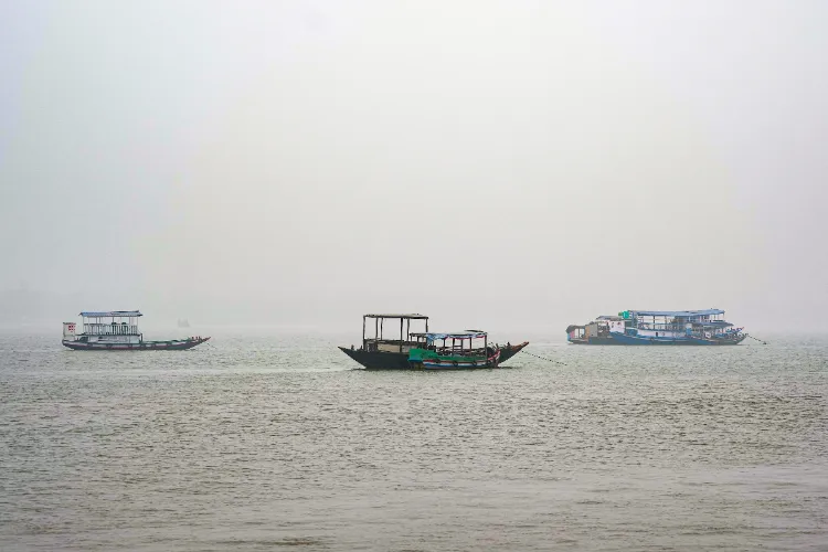 South 24 Parganas: Boats and ferries are anchored in the Durgaduani river on a foggy winter morning, at Gadkhali, in South 24 Parganas district, West Bengal