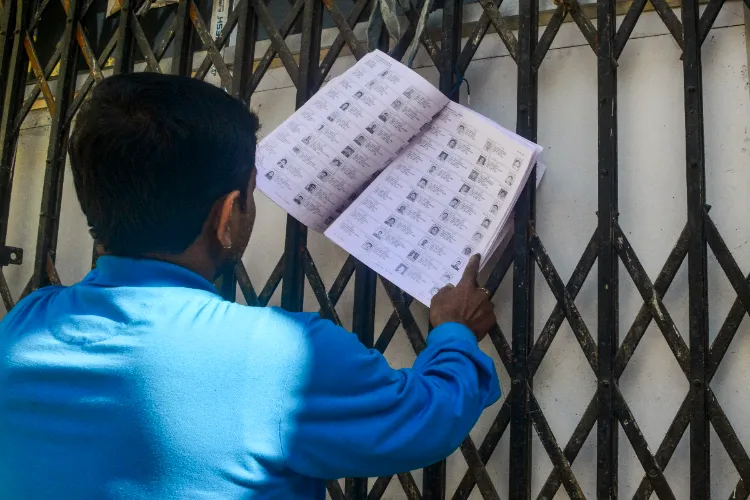 A voter checks his name from West Bengal's draft electoral rolls following special intensive revision (SIR), in Siliguri, West Bengal