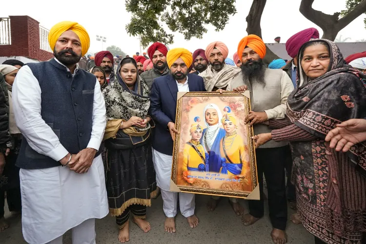 Punjab Chief Minister Bhagwant Mann, centre, being felicitated on 'Veer Bal Diwas', observed to mark the martyrdom anniversary of the sons of tenth Sikh Guru, Guru Gobind Singh, at Sri Fatehgarh Sahib, in Punjab