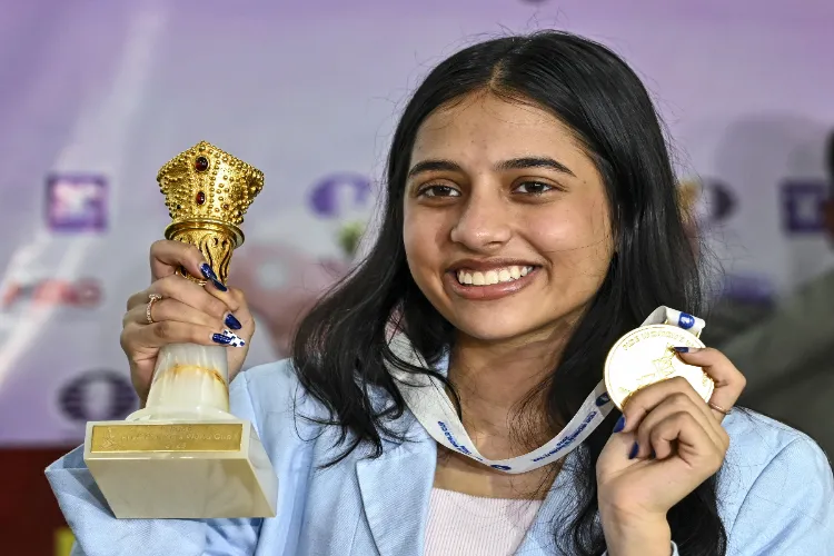 Grandmaster and Womens World Cup champion Divya Deshmukh poses with her trophy and medal during a press conference, in Nagpur, Maharashtra