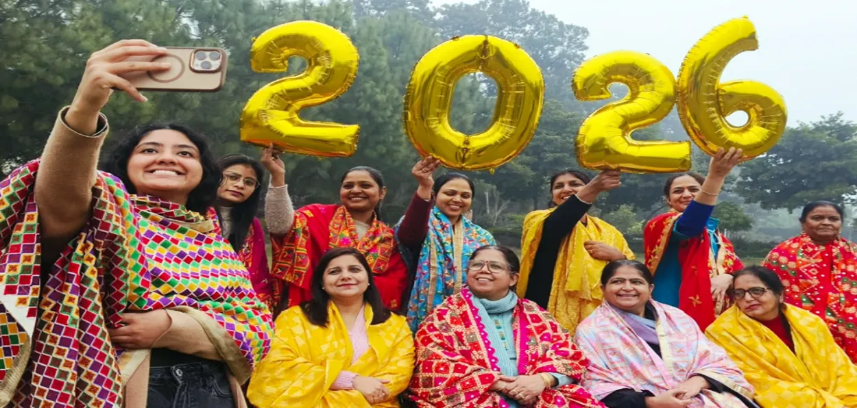 A group of women with '2026' placard pose as they celebrate the upcoming New Year 2026, in Patiala, Punjab