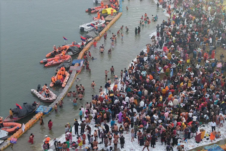 People take a holy dip at the Sangam on the occasion of 'Paush Purnima', marking the start of the 'Magh Mela' festival, on a cold winter morning, in Prayagraj