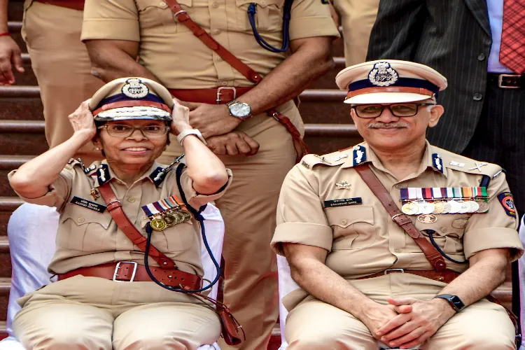 Maharashtra's first woman DGP Rashmi Shukla, left, receives a guard of honour alongside successor Sadanand Date on her retirement, in Mumbai
