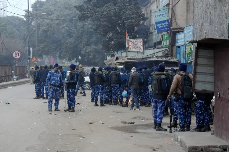 Police and security personnel stand guard near the Syed Faiz Elahi mosque after the demolition of alleged encroachments from a land adjoining the mosque carried out by the Municipal Corporation of Delhi (MCD), at Turkman Gate area, in New Delhi
