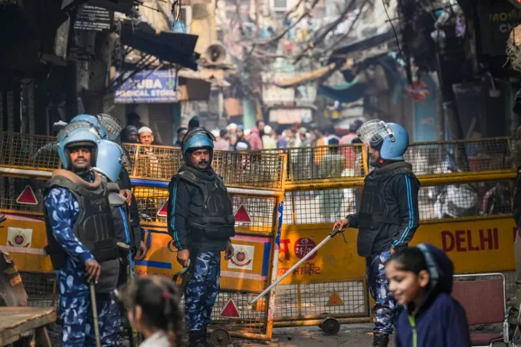 Security personnel keep vigil at a barricaded area following an anti-encroachment drive near the Faiz-e-Elahi mosque on the intervening night of Tuesday and Wednesday, which triggered violence, opposite the Turkman Gate area in New Delhi