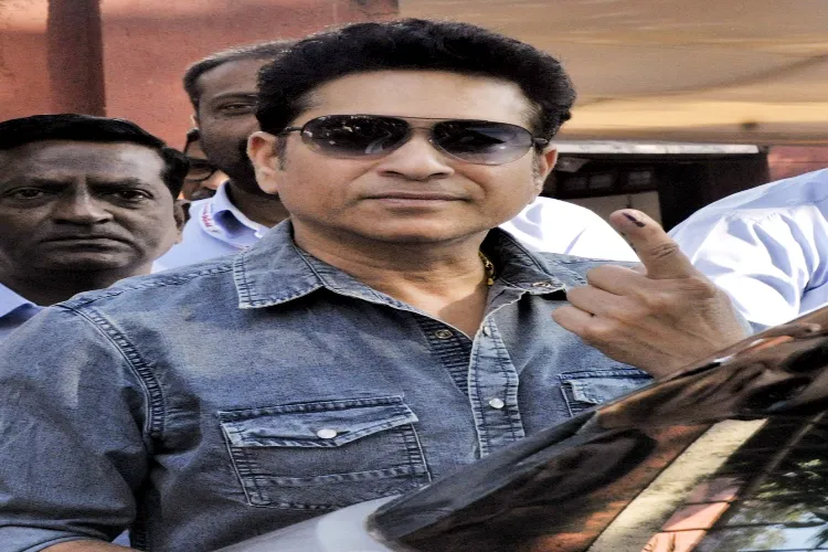 Former cricketer Sachin Tendulkar shows his ink marked finger after casting vote at a polling station during the Brihanmumbai Municipal Corporation (BMC) elections, in Mumbai, Maharashtra