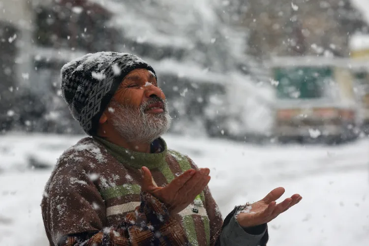 Doda: A citizen witnesses heavy snowfall at Bhaderwah, in Doda district, Jammu and Kashmir