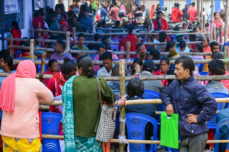 People wait in queues at a centre during hearings under the Special Intensive Revision (SIR) of electoral rolls, in Balurghat, Dakshin Dinajpur district, West Bengal
