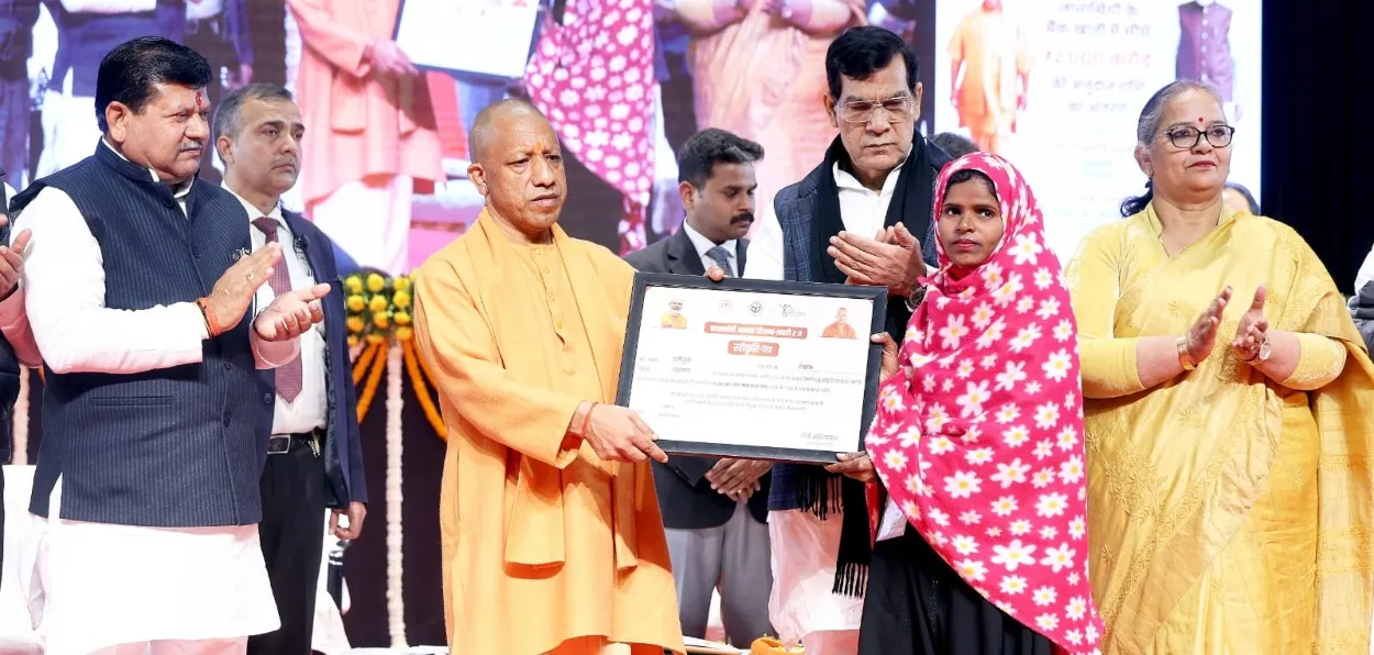 A Muslim woman receiving keys for her house under PMAY from CM Yogi Adiyta Nath
