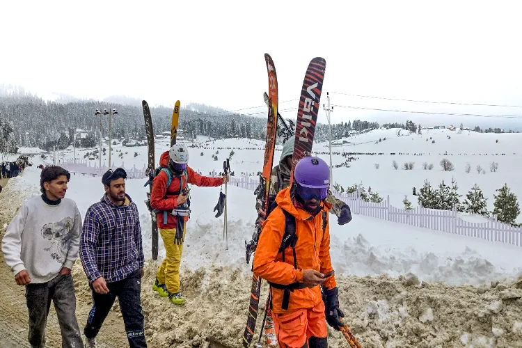 Gulmarg: Skiers walk on snow-covered slopes after fresh snowfall, in Gulmarg, Baramulla district