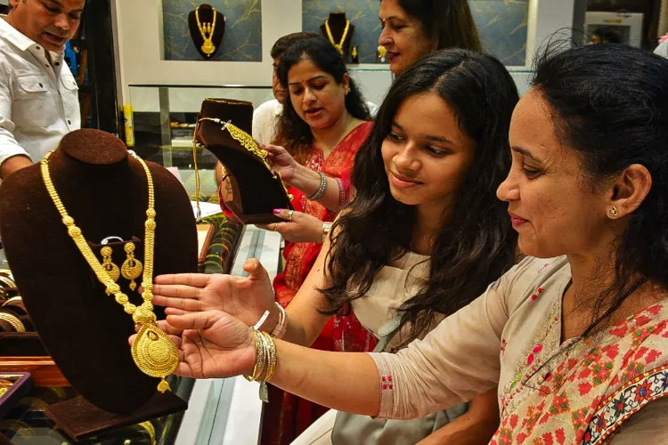 Women purchase jewellery at a showroom on the occasion of 'Dhanteras', in Thane, Maharashtra
