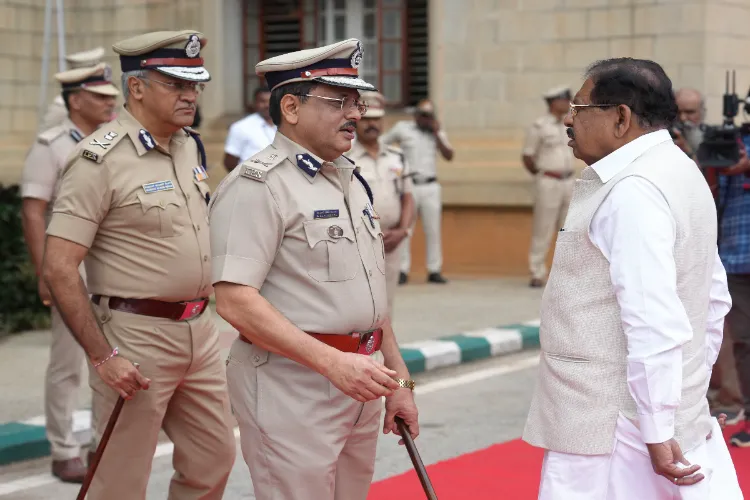 Karnataka Home Minister G. Parameshwara with DG&IGP M. A. Saleem and Bengaluru Police Commissioner Seemant Kumar Singh at the launch of new peak caps for policemen at Vidhana Soudha, Bengaluru.
