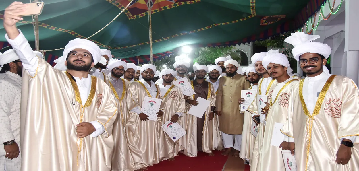Graduates wearing the traditional attire pose for the selfie during the Convocation of Jamia Nizamia in Hyderabad, India
