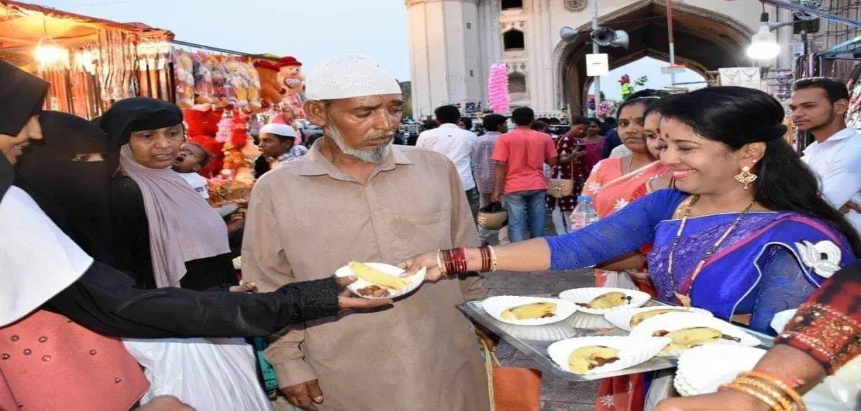 A Hindu woman distributing Iftar meal during Ramzan in Hyderabad