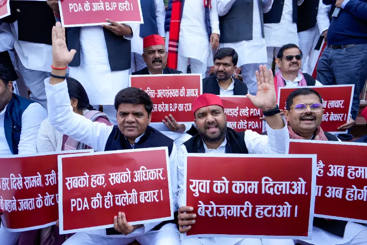 Samajwadi Party leaders stage a protest during the Budget Session of the Uttar Pradesh Assembly, at Vidhan Bhawan in Lucknow