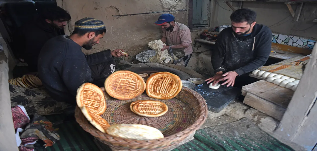 A Baker in Srinagar is making special flat bread for people to eat at Sehri on the first Ramzan (Basit Zargar)