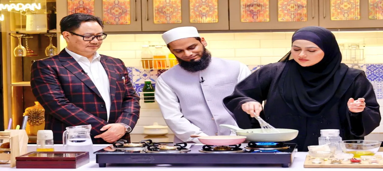 Minister of Minority Affairs Kiren Rijiju looks at as Sana Khan is cooking and her husband Mufti Anas Syed smiles (X of Kiren Rijiju)