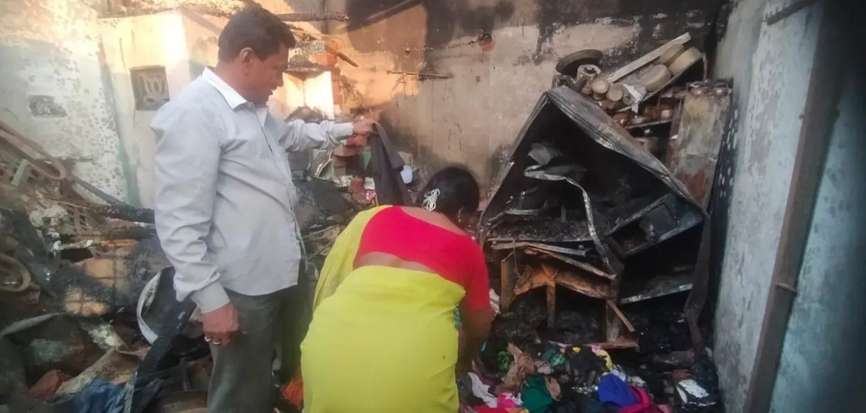 The couple salvaging their belongings from the dutted house