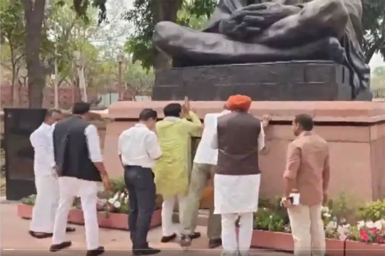 Opposition MPs at the statue of Mahatma Gandhi inside Parliament Complex