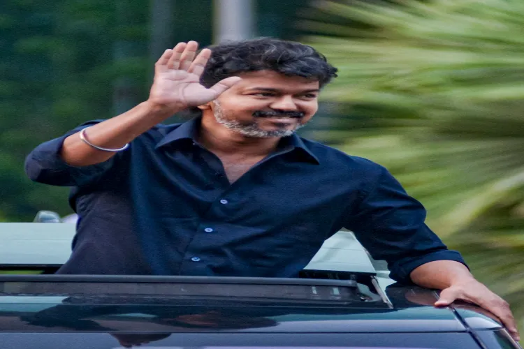 Actor and TVK chief Vijay waves as he leaves the CBI headquarters after questioning over last year's stampede during his rally in Tamil Nadu's Karur that claimed 41 lives