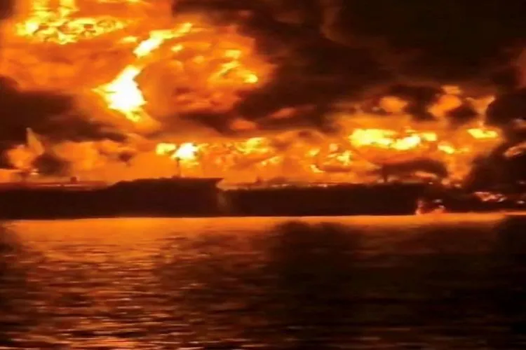 A ship burns, after Iranian explosive-laden boats appear to have attacked two fuel tankers in Iraqi waters