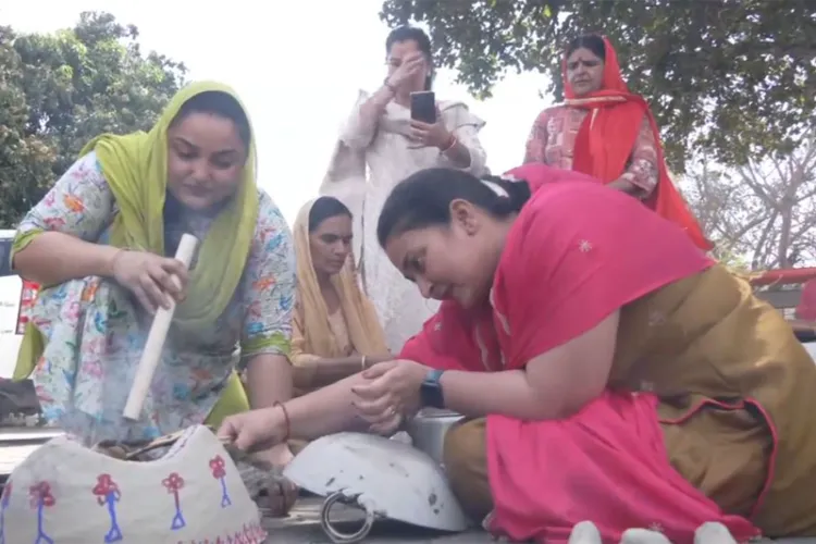 Women cooking food in traditional earthen stoves and firewood in Sainik Colony 