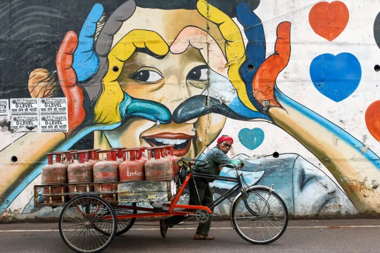 A worker pulls an LPG cylinder amid reports of a nationwide shortage of LPG gas cylinders 