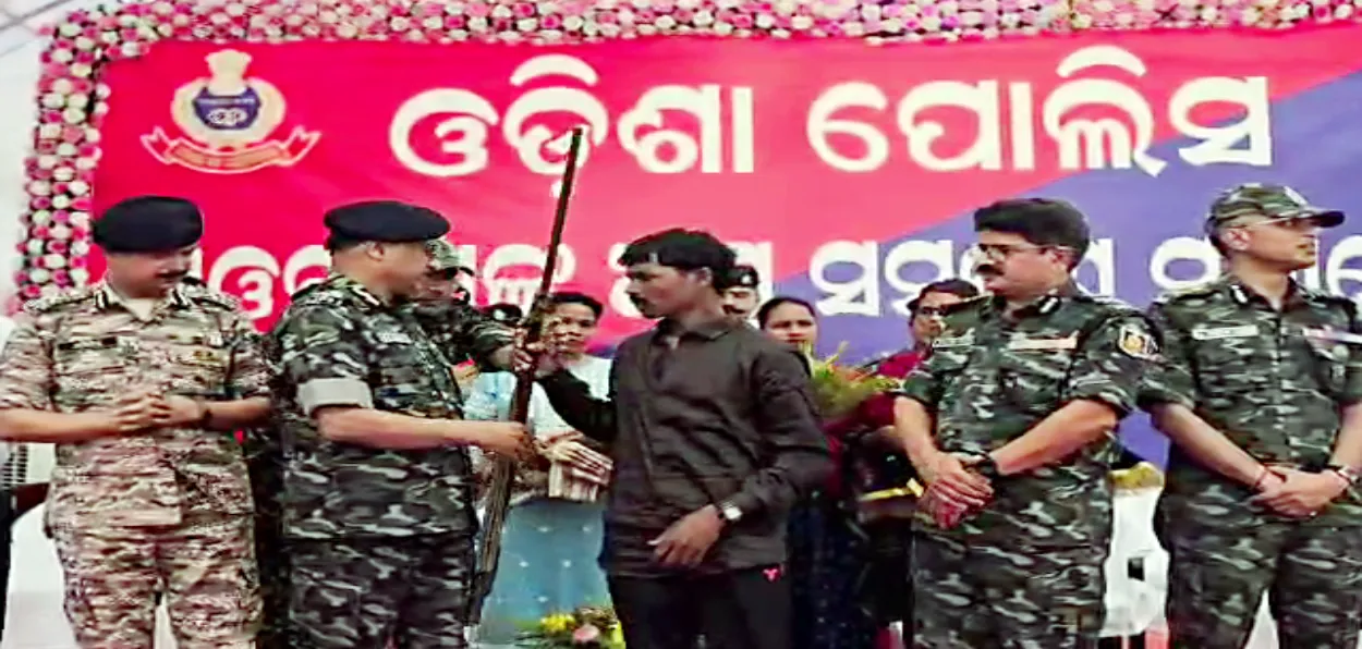 A Maoists from Bansadhara Gumusar Nagbali hands over his weapon in Kalahandi