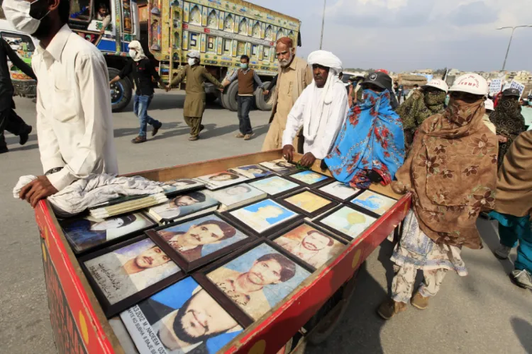 Relatives display pictures of people who have gone missing in Balochistan